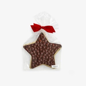 Star-shaped chocolate with hazelnuts in clear gift bag with red ribbon.